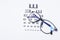 Top view of eye chart with glasses, ophthalmologist concept