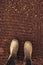 Top view of farmer rubber boots on ploughed arable land