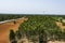 Top view of a farming field ready for ready for seeding after ploughing the field greenery trees around  that looking beautiful.