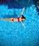 Top view of Fashion bikini tanned model in blue water swimm