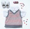 Top view fashion trendy look of baby boy clothes with sweets and