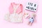 Top view fashion trendy look of baby girl clothes and toy stuff. Babyshower concept