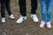 Top view of a father with his two little daughters feet wearing sports shoes.