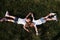 Top view. Feeling freedom. Two female kids lying on the green grass at summertime