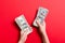 Top view of female hand giving some money, Close-up of counting one hundred dollar bills. Business concept on colorful background