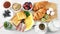 Top view female hand putting bakery croissant on serving table ready for breakfast POV shot