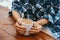 Top view female hands embrace hot drink mug on a wooden table