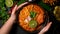 Top view, Female serving a Khao Soi Kai bowl. Northern Thai cuisine