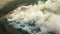 Top view of a fire at a landfill with plastic waste. An environmental disaster