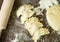 Top view of five dumplings with cherries. Traditional Ukrainian summer dumplings, rolling pin, dough on the dark table