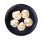 Top view of five khinkali on black plate isolated