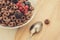 top view of flakes with berries/flakes with berries and a spoon on a wooden background. Top view