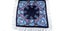 Top view on flat dark blue cotton scarf with fringe and bright floral ornament