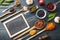 Top view of flat lay of assortment of legumes on black wooden tabletop, in scoop and ladles and a small blackboard