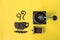 Top view flat lay coffee beans in cup and smell icon shape and vintage wooden coffee grinder on yellow background