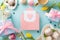Top view flat lay of cupcakes, gifts, postcard, coffee, and tulips on a pastel blue background