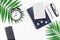 Top view flat lay office workspace desk styled design office supplies alarm clock tropical palm leaves smartphone copy space black