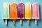 Top view flat lay of a set of bright ice cream popsicles