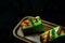 Top view of fluffy pieces of green cake on wooden tray on black satin background