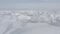 Top view of the fluffy snowy tops of a winter valley