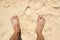 Top view foot guy on sandy beach
