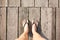 Top view foot of young woman with shoe standing alone on wood fl