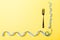 Top view of fork and curled measuring tape on yellow background. Diet concept with copy space
