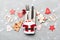Top view of fork and knife tied up with ribbon on napkin on cement background. Close up of christmas decorations and New Year tree