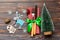 Top view of fork and knife tied up with ribbon on napkin on wooden background. Close up of christmas decorations and New Year tree