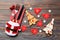 Top view of fork and knife tied up with ribbon on napkin on wooden background. Close up of christmas decorations and New Year tree