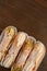 Top view of four delicious cannoli on wooden background