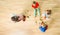 Top view of four kids constructing of wooden blocks
