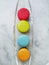 Top view of four macarons on vertical line