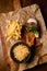 top view of french fries and bowl of sauerkraut and delicious batter fried pork ears