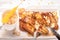 Top view french toast sliced and fried with honey, maple syrup and butter. Served on a white plate with silverware and cup of