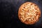 Top view of fresh baked pizza on dark wooden background