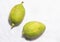 Top view of fresh green lemons placed in a white copy space background.