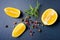 Top view of fresh lemon, rosemary and various peppers on slate background