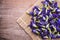 Top view fresh purple Butterfly pea flower on wooden board background