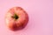 Top view of fresh red apple isolated on a pink background