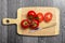 Top view of fresh tomatoes and knife on chopping board