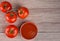 Top view of Fresh tomatoes and tomatoe paste on a wooden table