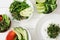 Top view of fresh vegetables and fruits with microgreen in bowls