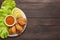 Top view fried chicken wings on dish on wooden background.