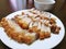 Top view of fried pork crackling in white plate on wooden table