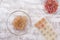 Top view of frozen ice cube made from dry rose petals for skin care on the white background