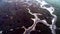 Top view of frozen river. Shot. Scenic view on top of frozen river with remnants of snow melt and surrounded dirty, wet