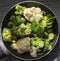 Top view of a frying pan with fresh defrosted vegetables: cauliflower, broccoli, Brussels sprouts