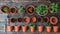 Top View Gardening Composition with Tools and Flowerpots on Wooden Table