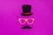 top view of gentleman face made of cardboard eyeglasses, mustache and hat